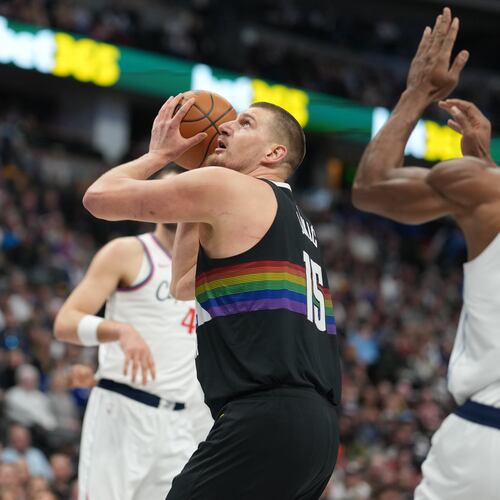 Denver Nuggets center Nikola Jokić (15) goes up for a basket as Los Angeles Clippers forward Kawhi Leonard (2) defends in the first half of an NBA basketball game Friday, Jan. 30, 2026, in Denver. (AP Photo/David Zalubowski)