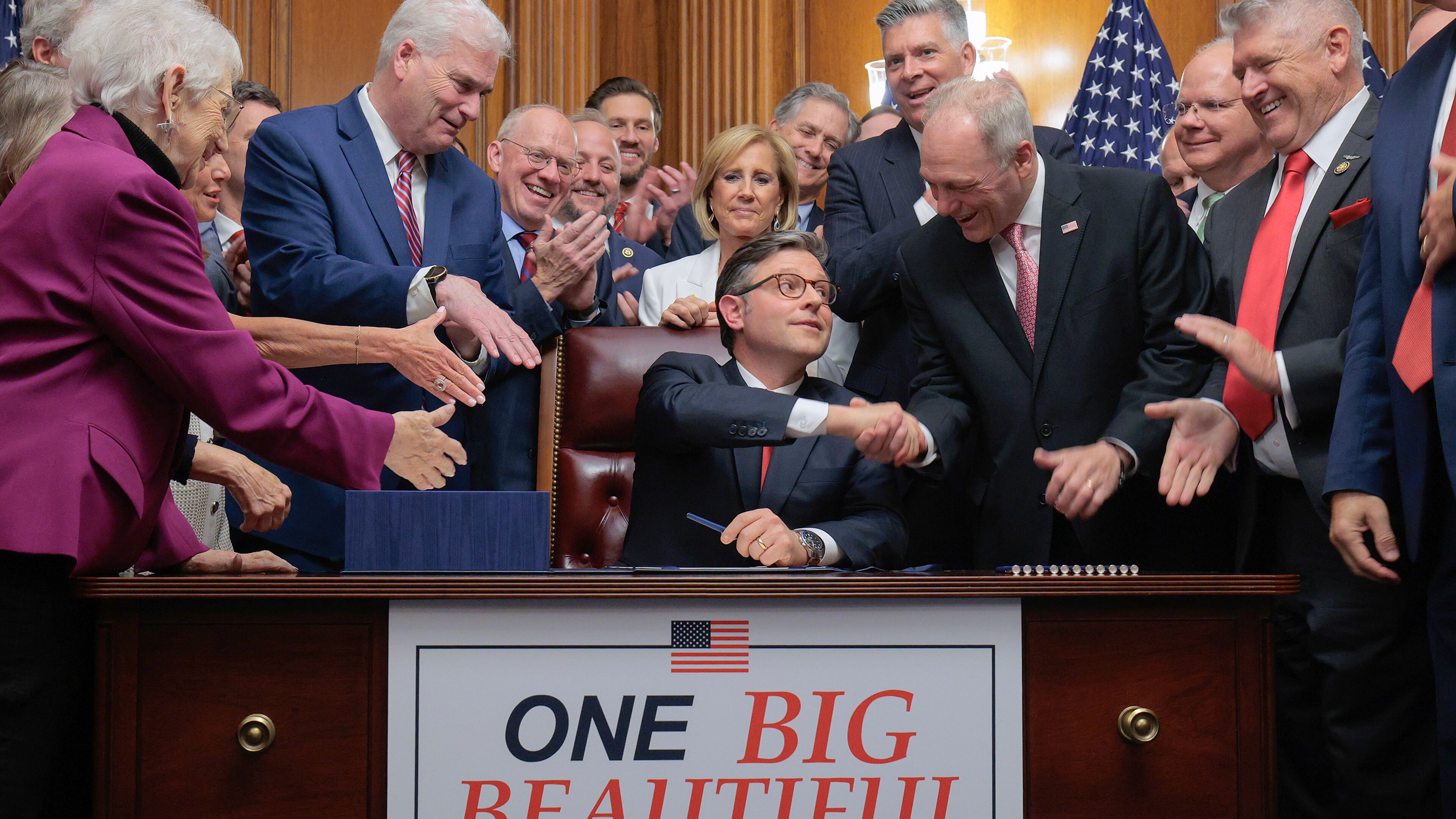 Speaker of the House Mike Johnson (R-LA) (C) is congratulated by his fellow Republicans after signing the One Big Beautiful Bill Act during an enrollment ceremony in the Rayburn Room at the U.S. Capitol on July 03, 2025, in Washington, DC. (Chip Somodevilla/Getty Images)