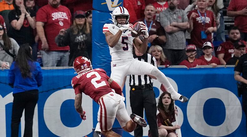 Arizona wide receiver Montana Lemonious-Craig (5) catches a pass in front of Oklahoma defensive back Billy Bowman Jr. (2) for a two-point conversion during the Alamo Bowl NCAA college football game in San Antonio, Texas, on Thursday, Dec. 28, 2023. (Eric Gay/AP)