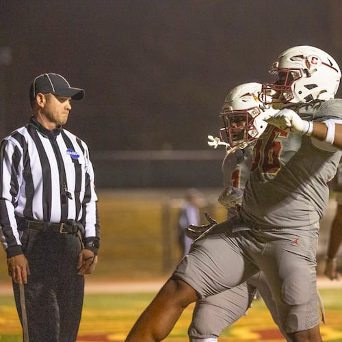 Creekside runing back Gary Walker (1) celebrates the game-winning touchdown with teammate Lawrence Martin II (56) during the second half of the class 4A semifinal against Kell at Creekside High School in Fairburn, GA on Friday, December 5, 2025. (Oscar Guevara Saenz for the AJC)