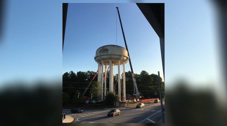 A crane began dismantling the water tower on Monday.