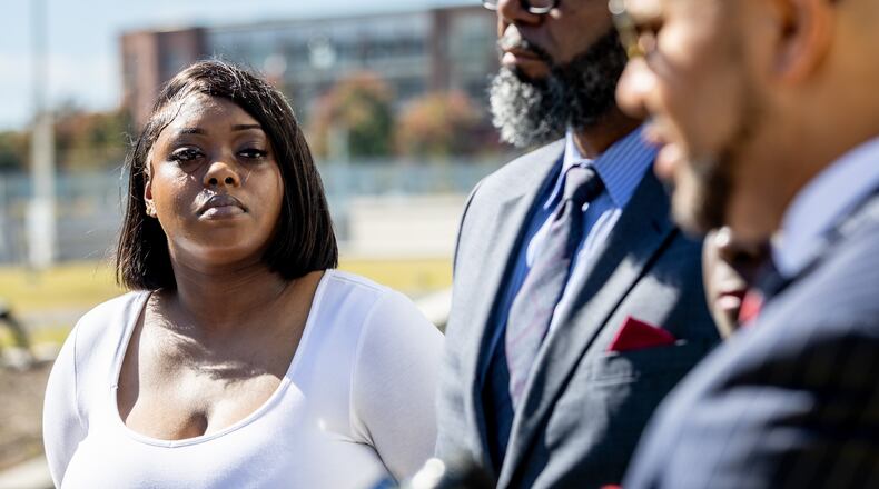 Plaintiff Martrice Herrington listens to state representatives, legal advocates, and lawyers speak on the steps of the Richard B. Russell Federal Building, announcing the federal lawsuit against the Georgia Board of Regents on Tuesday, Oct. 24, 2023.  (Steve Schaefer/steve.schaefer@ajc.com)