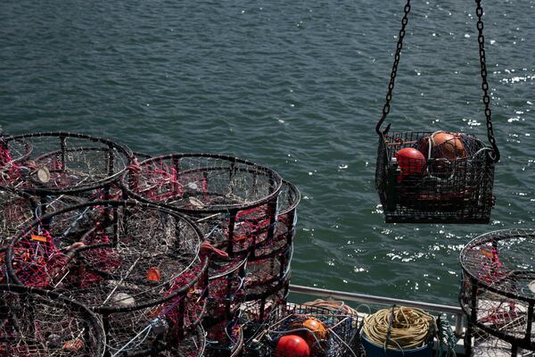 Pop-up gear that aims to prevent whale entanglements, right, is loaded onto the boat Pale Horse at Pier 45 in San Francisco, Thursday, April 10, 2025. (AP Photo/Emily Steinberger)