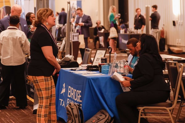 Attendees engage with vendors during morning sessions at the Georgia Technology Summit, organized by the Technology Association of Georgia and held at the Signia by Hilton by the Georgia World Congress Center on Thursday, March 28, 2024. (Miguel Martinez /AJC)
