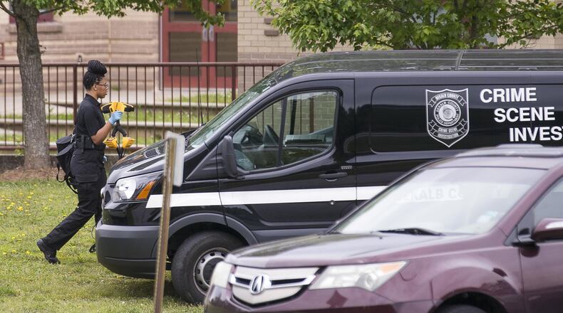 A DeKalb County Crime Scene Investigator carries her tools back to her vehicle outside of Wynbrooke Elementary School in Stone Mountain, Thursday, April 25, 2019. ALYSSA POINTER/ALYSSA.POINTER@AJC.COM