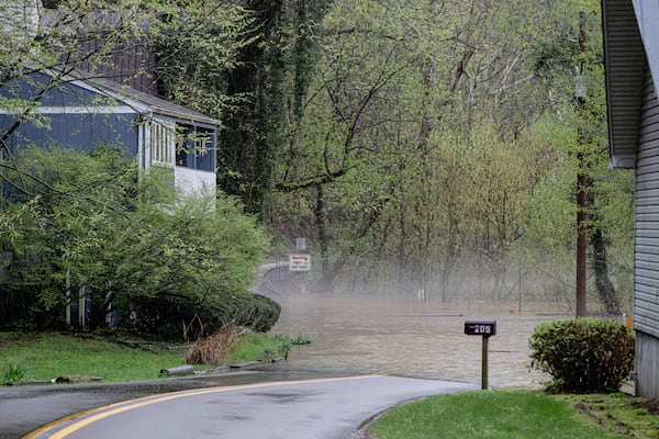 Fog rolls in over a flooded road near the banks of the Kentucky River on Saturday, April 5, 2025, in Frankfort, Ky. (AP Photo/Jon Cherry)