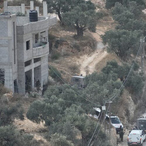 Israeli soldiers secure a building under construction as ambulances evacuate injured Palestinians following an attack by Israeli settlers in the occupied West Bank village of Qusra, Saturday, Aug. 29, 2026. (AP Photo/Majdi Mohammed)