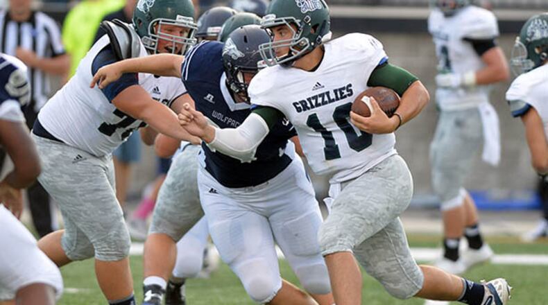 AUGUST 22, 2014 POWDER SPRINGS Walter H. Cantrell Stadium Friday, August 22, 2014. KENT D. JOHNSON / KDJOHNSON@AJC.COM Creekview quarterback Kyle Wilkie runs on the keeper during the first half in the initial game of the 2014 Corky Kell Classic between the Creekview Grizzlies and the North Paulding Wolfpack at McEachern High School. (Kent D. Johnson / AJC)
