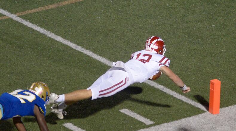 Hillgrove quarterback Matthew McCravy (12) dives for the end zone on the final play of the Friday’s game at McEachern. (Daniel Varnado/Special)