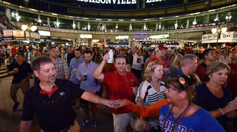 Georgia and Florida fans elebrate during an annual party at the Jacksonville Landing on the eve of the Georgia vs Florida game on Oct. 28, 2016.