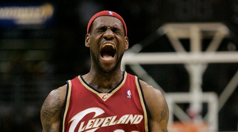 FILE - In this March 10, 2007, file photo, Cleveland Cavaliers forward LeBron James reacts to a shot made by teammate Anderson Varejao during the final seconds of the fourth quarter of an NBA basketball game in Milwaukee. James told Sports Illustrated on Friday, July 11, 2014, he is leaving the Miami Heat to go back to the Cleveland Cavaliers. (AP Photo/Morry Gash, File)