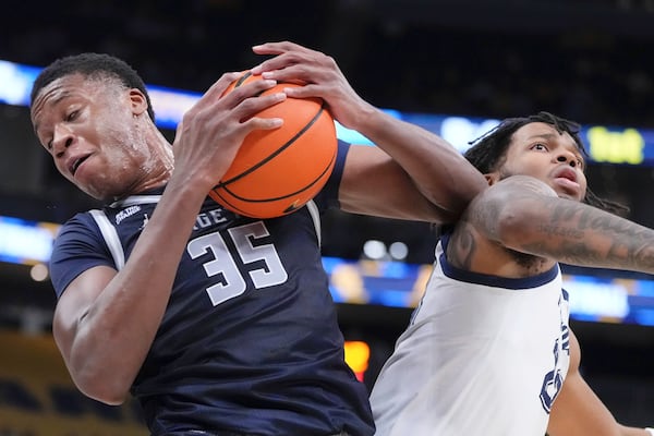 FILE - Marquette's Chase Ross and Georgetown's Thomas Sorber battle for a loose ball during the first half of an NCAA college basketball game Tuesday, Jan. 7, 2025, in Milwaukee. (AP Photo/Morry Gash, File)