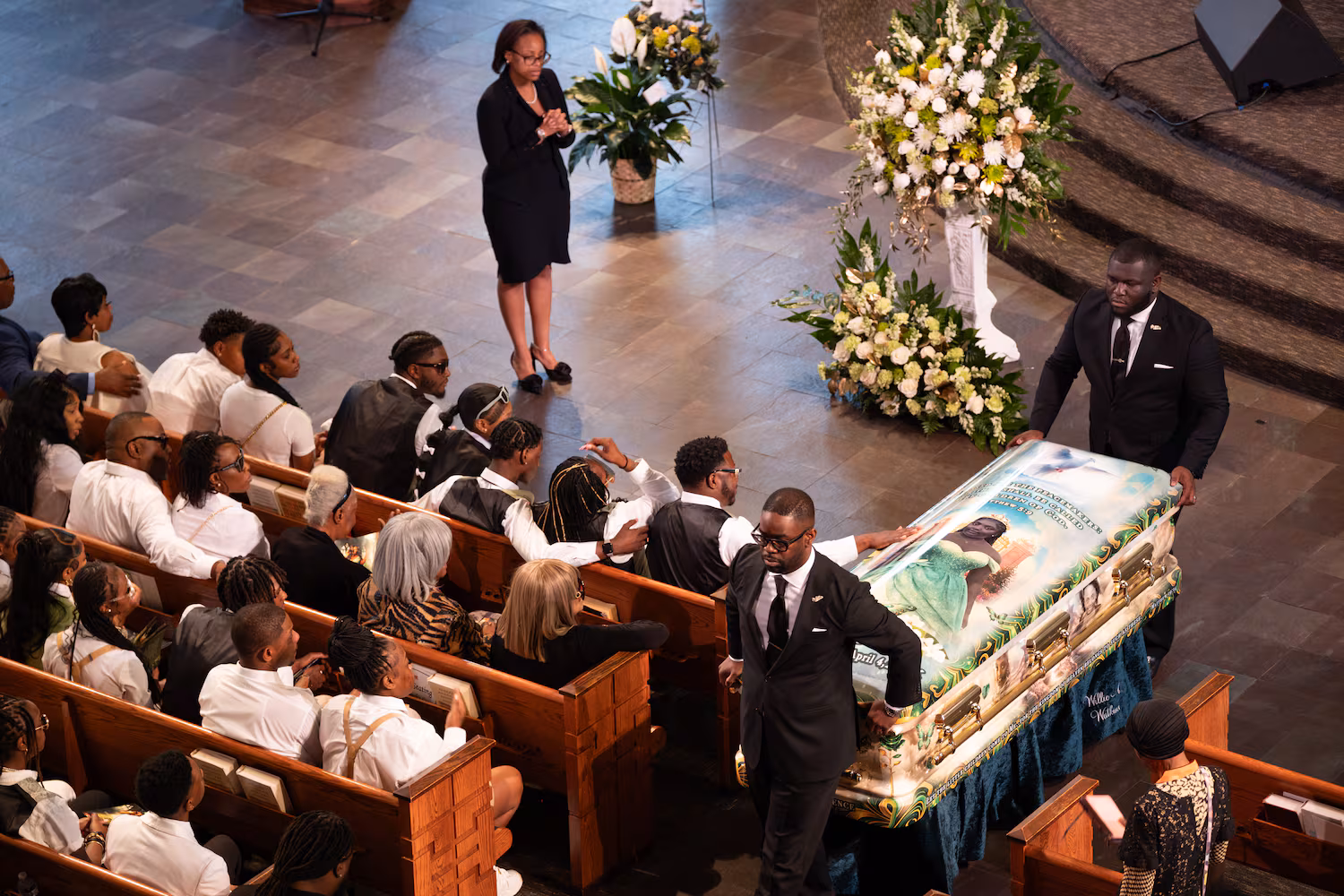 Tianah Robinson’s father touches her casket as it leaves Ebenezer Baptist Church following a celebration of life Saturday, April 18, 2026, in Atlanta. (Ben Gray for the AJC)