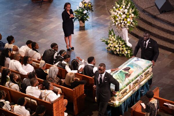 Tianah Robinson’s father touches her casket as it leaves Ebenezer Baptist Church following a celebration of life Saturday, April 18, 2026, in Atlanta. (Ben Gray for the AJC)