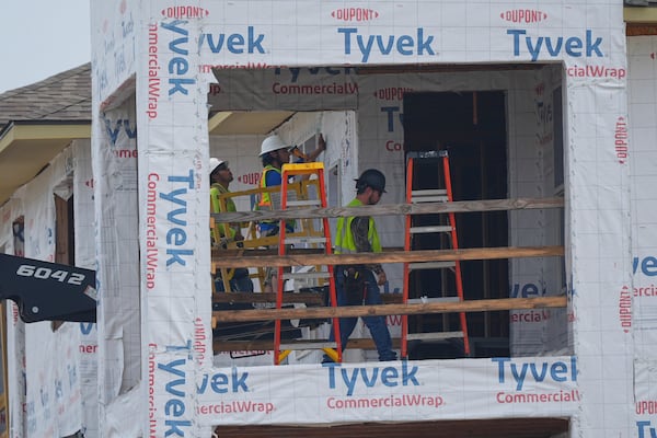 Construction workers build apartments in Princeton, Texas, Friday, May 16, 2025. (AP Photo/LM Otero)