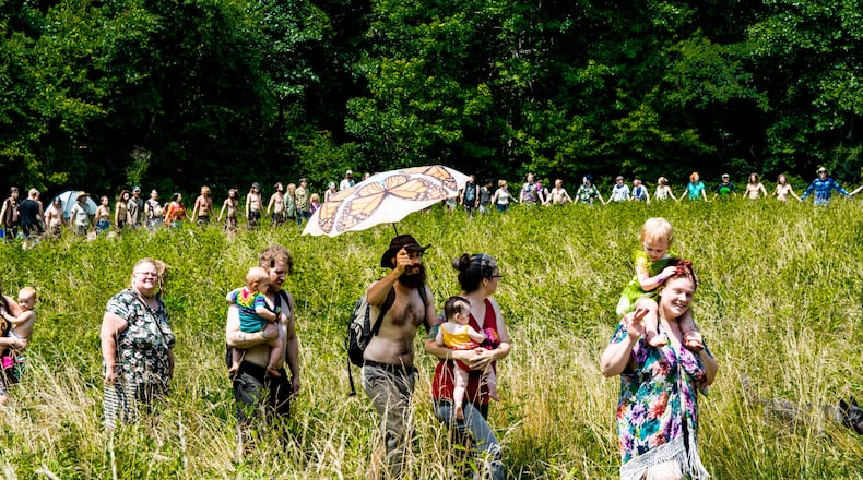 People gather in a meadow at the Rainbow Family of Living Light Gathering which took place for the first time in Georgia at Chattahoochee-Oconee National Forest. The event began as early as June 12, with the high point from July 1 through July 7, 2018. (Cynthia Herms/CynthiaHerms.com)