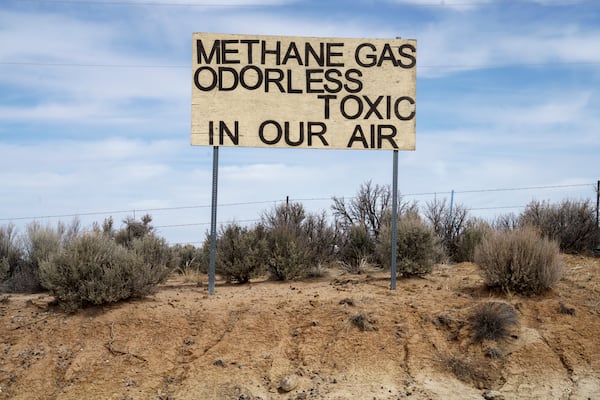 A sign protesting emissions from oil and gas stands across from Lybrook Elementary School, in Counselor, N.M., Navajo Nation, on Tuesday, March 11, 2025. (Nadav Soroker/Searchlight New Mexico via AP)