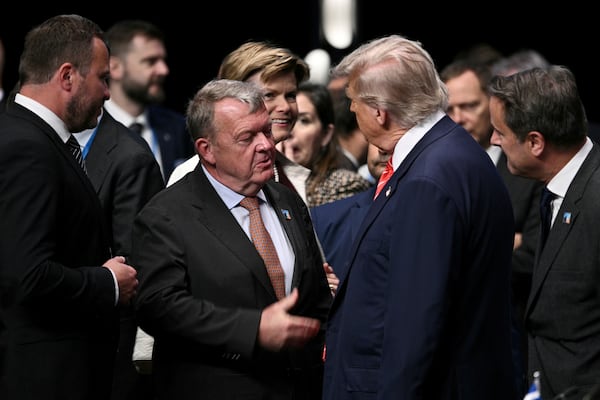 FILE - U.S. President Donald Trump greets Denmark's Foreign Minister Lars Lokke Rasmussen, center left, before the start of a plenary session of the NATO Heads of State and Government summit in The Hague, Netherlands, June 25, 2025.(Brendan Smialowski/Pool Photo via AP File)