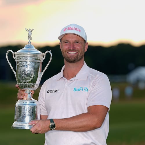 Wyndham Clark holds the trophy after winning the U.S. Open golf tournament at Shinnecock Hills Golf Club in Southampton, N.Y., Sunday, June 21, 2026. (AP Photo/Gerald Herbert)