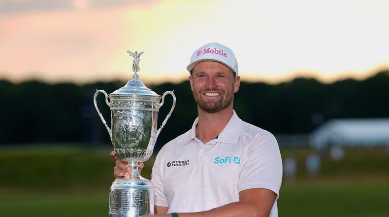 Wyndham Clark holds the trophy after winning the U.S. Open golf tournament at Shinnecock Hills Golf Club in Southampton, N.Y., Sunday, June 21, 2026. (AP Photo/Gerald Herbert)