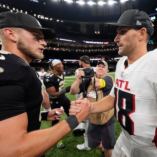 New Orleans Saints quarterback Tyler Shough (6) and Atlanta Falcons quarterback Kirk Cousins (18) shake hands after an NFL football game, Sunday, Nov. 23, 2025, in New Orleans. (AP Photo/Gerald Herbert)