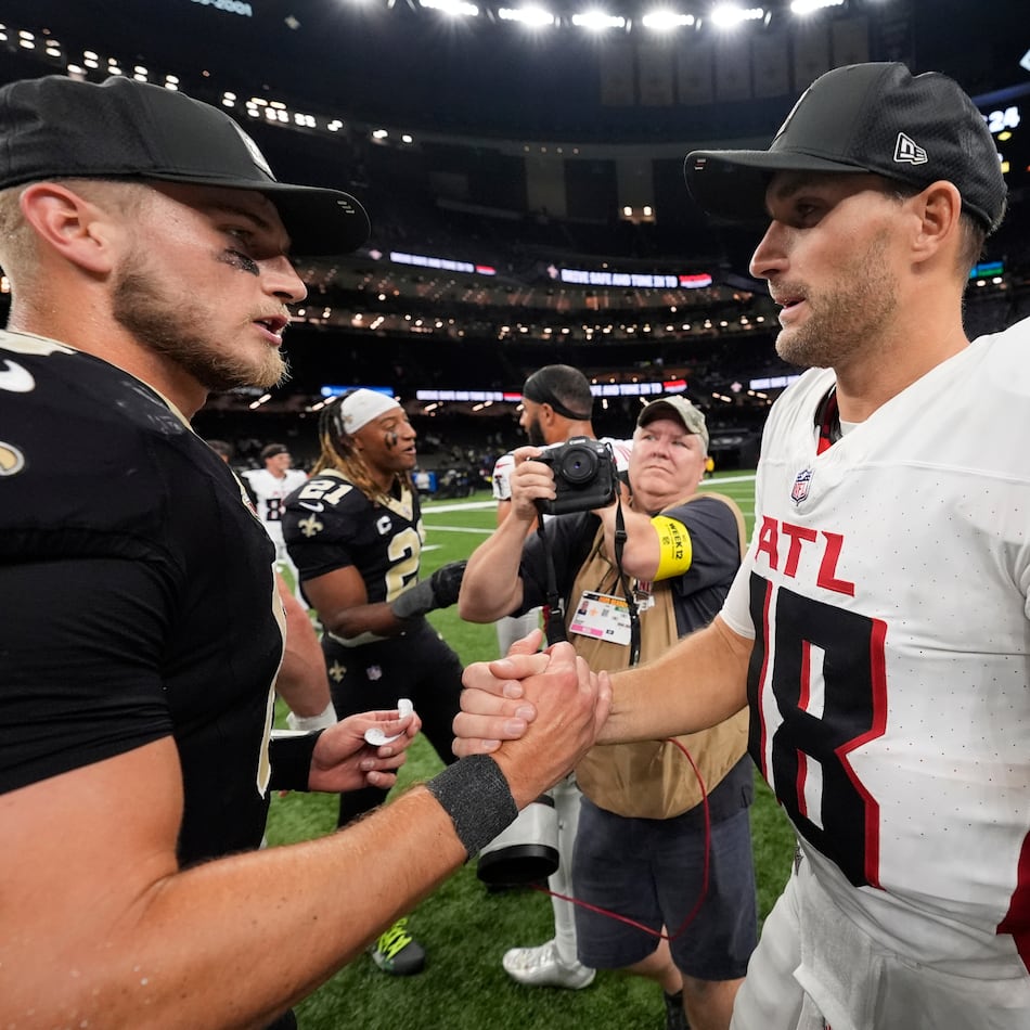 New Orleans Saints quarterback Tyler Shough (6) and Atlanta Falcons quarterback Kirk Cousins (18) shake hands after an NFL football game, Sunday, Nov. 23, 2025, in New Orleans. (AP Photo/Gerald Herbert)