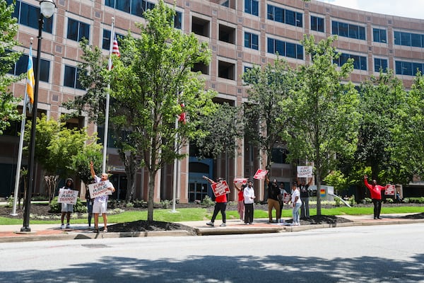 Protesters hold signs outside of the MARTA Headquarters in Atlanta on Thursday, June 11, 2026. (Abbey Cutrer/AJC)