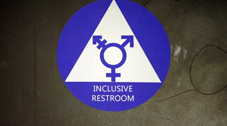A new sticker designates a gender neutral bathroom at Nathan Hale High School Tuesday, May 17, 2016, in Seattle. President Obama's directive ordering schools to accommodate transgender students has now prompted a lawsuit by 11 states, but since 2012 Seattle has mandated that transgender students can use the bathrooms and locker rooms of their choice. (AP Photo/Elaine Thompson)