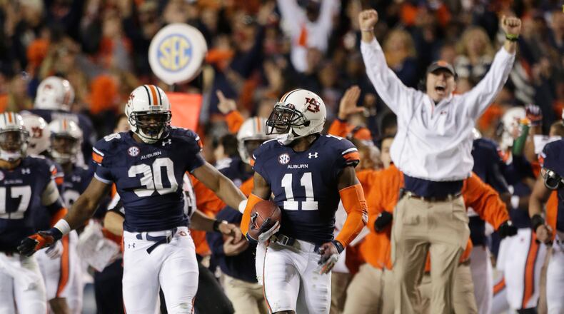 Auburn cornerback Chris Davis (11) returns a missed field-goal attempt 100-plus yards to score the game-winning touchdown as time expired in the fourth quarter of an NCAA college football game against No. 1 Alabama in Auburn, Ala., Saturday, Nov. 30, 2013. Auburn won 34-28. (AP Photo/Dave Martin)