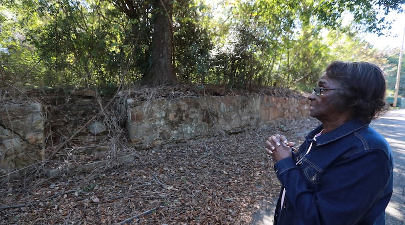 Wilma Abbott Nichols, 80, visits the crumbling wall and foundation of her former home on Columbia Avenue where a large scale development is planned on Wednesday, October 23, 2019, in College Park. Nichols’ home and others were torn down because of the noise from the airport. Curtis Compton/ccompton@ajc.com