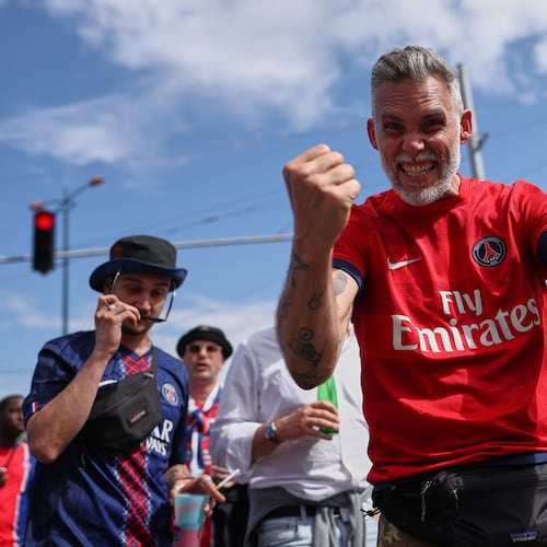 PSG supporters react as they make their way to the stadium ahead of the Champions League final soccer match between Paris Saint-Germain and Arsenal in Budapest, Hungary, Saturday, May 30, 2026. (AP Photo/Rudolf Karancsi-Albert)