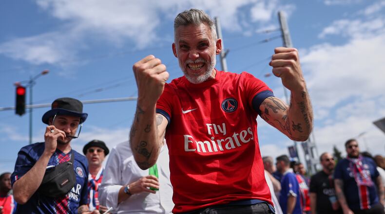 PSG supporters react as they make their way to the stadium ahead of the Champions League final soccer match between Paris Saint-Germain and Arsenal in Budapest, Hungary, Saturday, May 30, 2026. (AP Photo/Rudolf Karancsi-Albert)