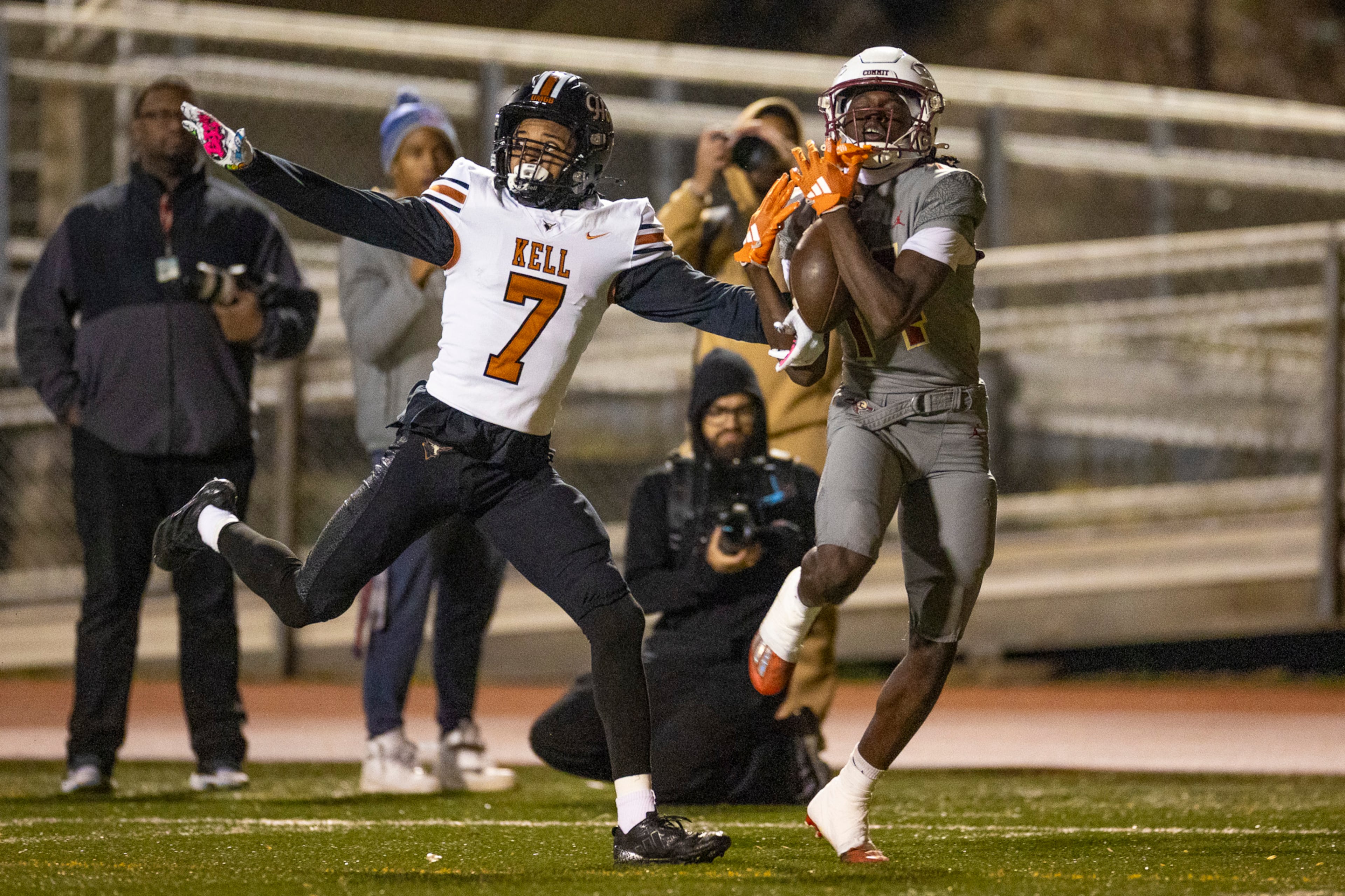 Creekside wide receiver Armani Hill (right) makes a catch while Kell defensive back Robert Tyson Jr. (left) tries to intercept during the first half of the class 4A semifinal against Kell at Creekside High School in Fairburn, GA on Friday, December 5, 2025. (Oscar Guevara Saenz for the AJC)