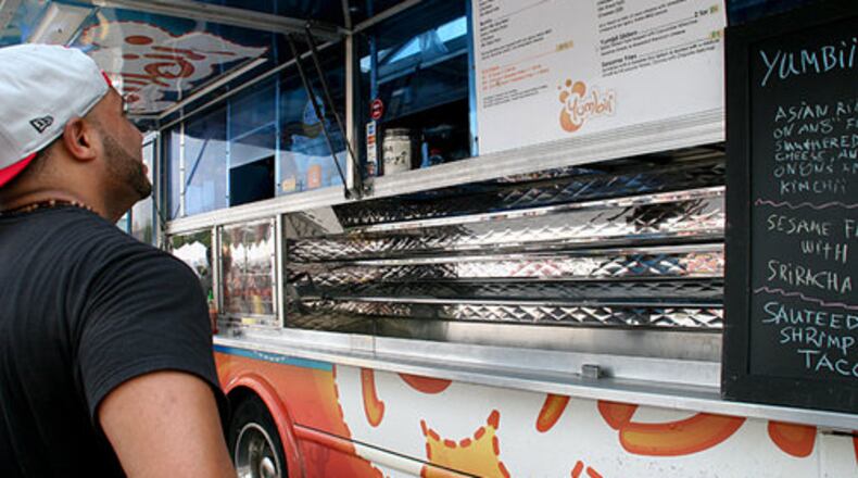 Jae LeRarre orders food from one of the food trucks, Yumbii, in this file photo.