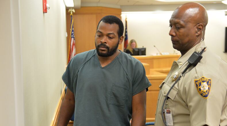 Recardo Wimbush leaves court during a break in a bond hearing before Gwinnett County Superior Court Judge Karen Beyers Tuesday, August 5, 2014. The former Georgia Tech football star and his wife were denied bond. They are accused of locking their 13-year-old son in the basement for months.