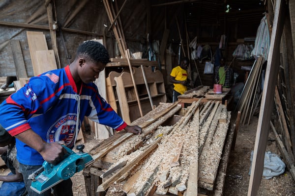 Diode works in a carpentry shop powered in part by solar energy in Goma, Congo, May 23, 2024. (AP Photo/Moses Sawasawa)