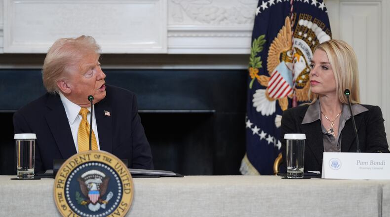 President Donald Trump speaks during a roundtable on criminal cartels in the State Dining Room of the White House, Thursday, Oct. 23, 2025, in Washington, as Attorney General Pam Bondi listens. (AP Photo/Evan Vucci)