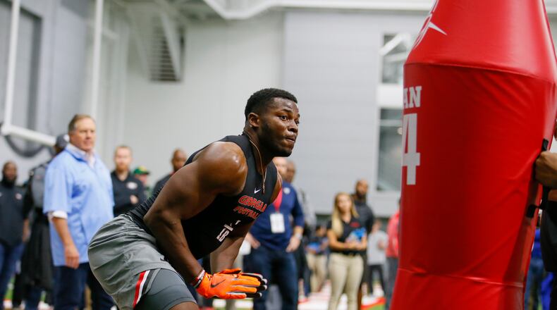 Georgia linebacker Lorenzo Carter participates in a drill as New England Patriots head coach Bill Belichick, left, watches, during Georgia Pro Day, Wednesday, March 21, 2018, in Athens. Pro Day is intended to showcase talent to NFL scouts for the upcoming draft. (AP Photo/Todd Kirkland)