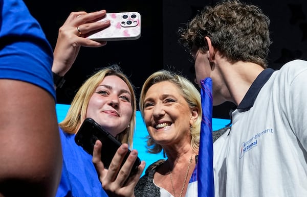 FILE - Leader of the French far right National Rally Marine Le Pen poses for a selfie with supporters during a meeting for the upcoming European elections in Henin-Beaumont, northern France, Friday, May 24, 2024. (AP Photo/Michel Euler, File)