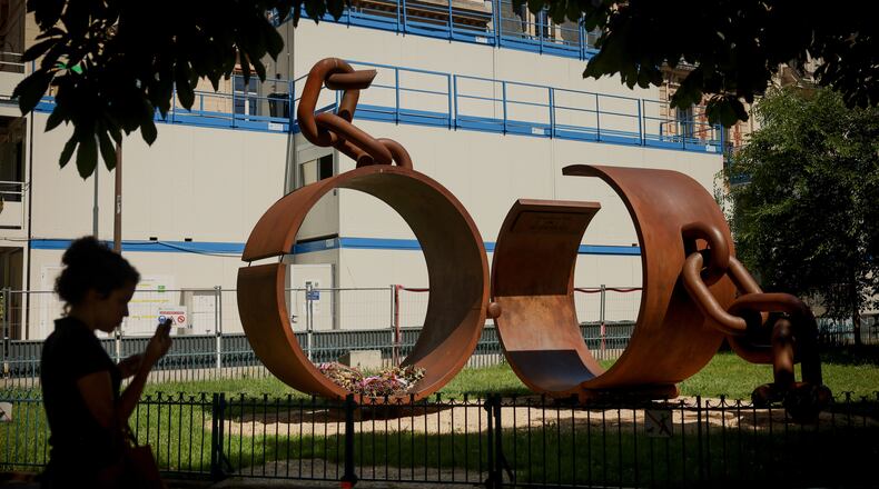 A statue named "Chains," by French artist Driss Sans-Arcidet, honoring the memory of the abolition of slavery, is photographed in a park in Paris, Wednesday, May 27, 2026, as France's National Assembly examines a bill to formally repeal the Code Noir, or Black Code, the 17th-century royal edict that governed slavery in French colonies and treated enslaved people as property. (AP Photo/Thomas Padilla)
