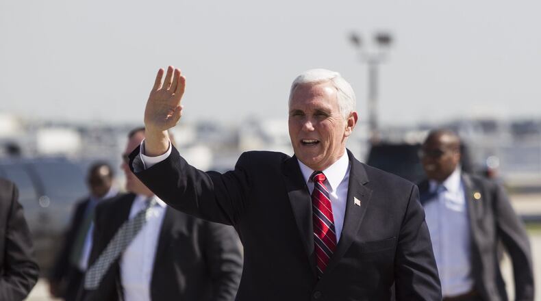 Vice President Mike Pence waves at friends and family after landing Friday at Hartsfield-Jackson International Airport in Atlanta. During his visit, he talked up the $1.5 trillion package of federal tax cuts that Republicans pushed through Congress last year, and he helped the Georgia GOP raise money to try to erase its debt of more than $600,000. (REANN HUBER/REANN.HUBER@AJC.COM)