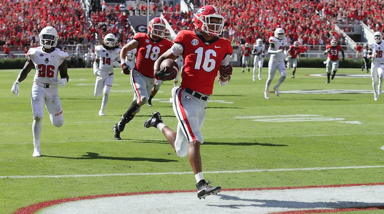 Georgia Bulldogs wide receiver Demetris Robertson breaks away from Austin Peay defenders for a touchdown and a 24-0 lead during the second quarter in a NCAA college football game on Saturday, Sept 1, 2018, in Athens. Curtis Compton/ccompton@ajc.com