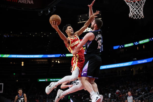 Atlanta Hawks forward Zaccharie Risacher, left, attempts a shot against Utah Jazz guard Svi Mykhailiuk (19) in the first half of an NBA basketball game, Sunday, April 6, 2025, in Atlanta. (AP Photo/Colin Hubbard)