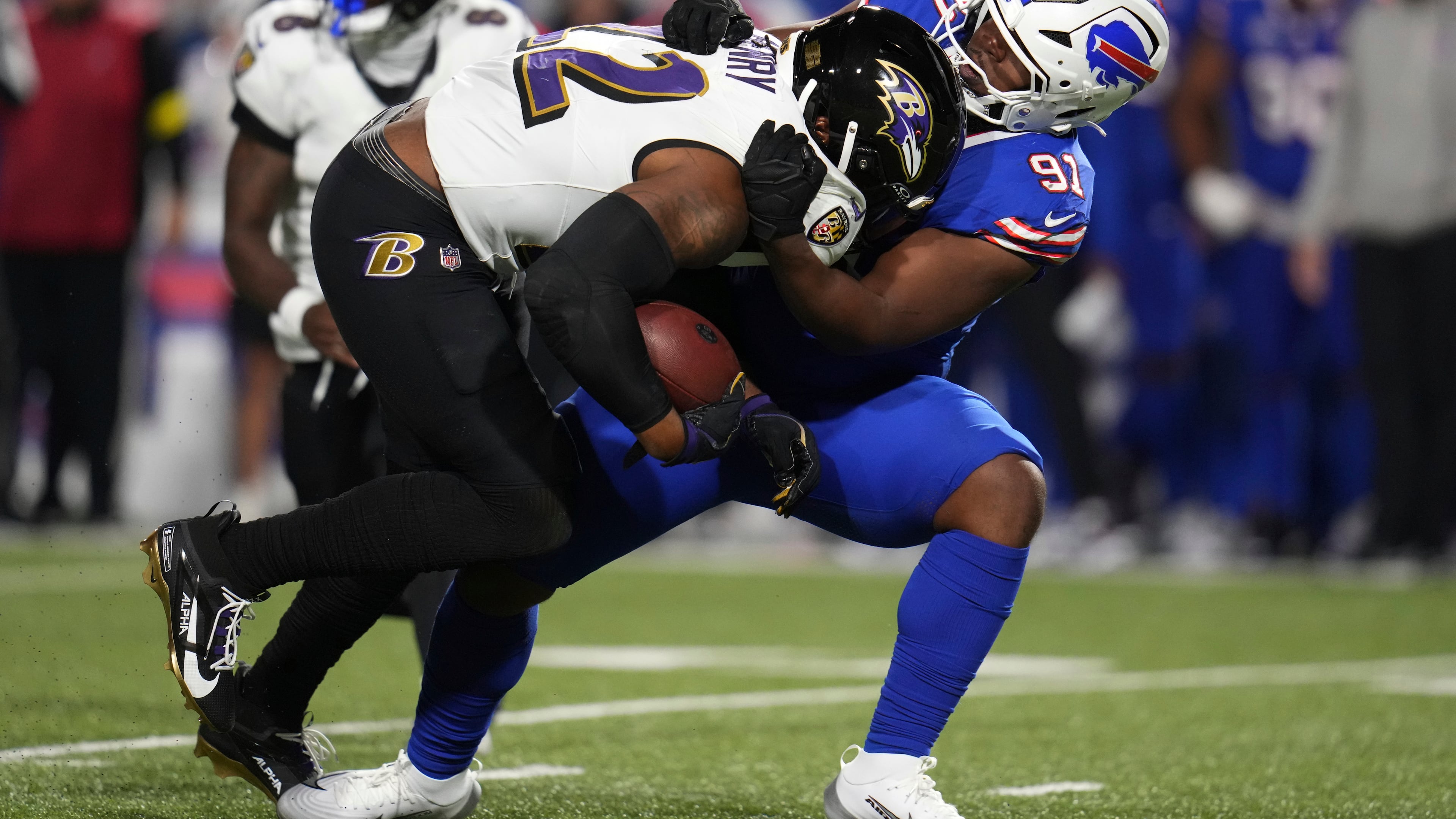 Baltimore Ravens running back Derrick Henry (22) is stopped by Buffalo Bills defensive tackle Ed Oliver (91) during the second half of an NFL football game in Orchard Park, N.Y., Sunday, Sept. 7, 2025. (AP Photo/Gene J. Puskar)