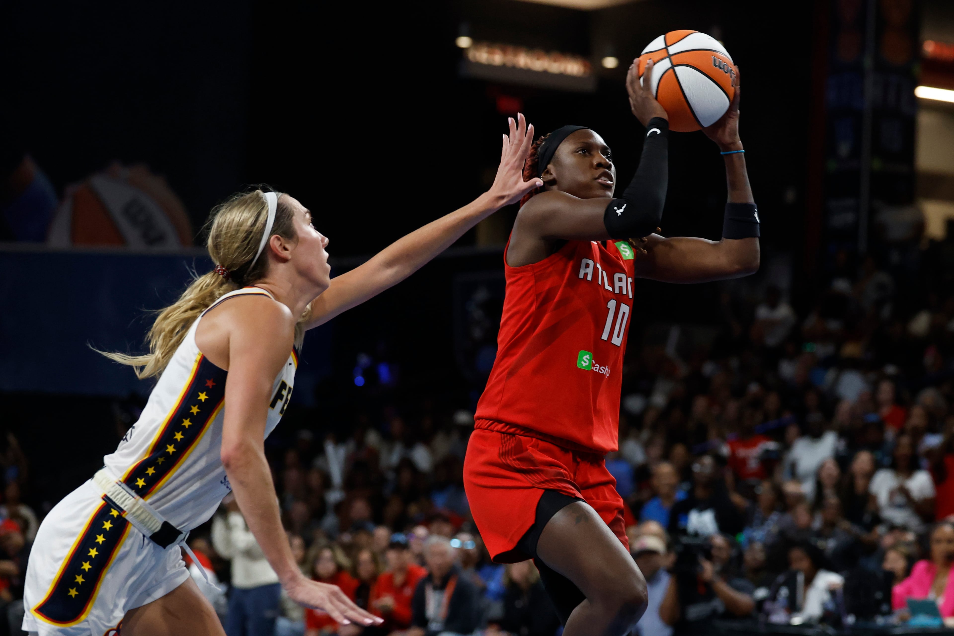 Atlanta Dream guard Rhyne Howard, right, looks to shoot as Indiana Fever guard Lexie Hull, left, defends during the second half of Game 3 in the first round of the WNBA basketball playoffs, Thursday, Sept. 18, 2025, in Atlanta. (AP Photo/Butch Dill)