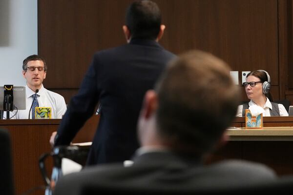 Dr. Jeremy Smiley, left, answers a question from Lake County Assistant State's Attorney Ben Dillon during the sentencing hearing for Robert E. Crimo III., at the Lake County Courthouse, in Waukegan, Ill., Wednesday, April 23, 2025. (AP Photo/Nam Y. Huh, Pool)