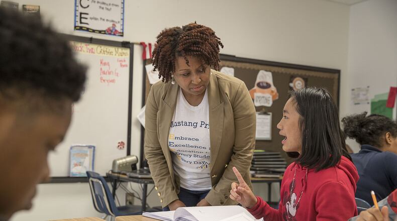 Cliftondale Elementary School principal Miranda Freeman interacts with a fifth grader who is completing a writing prompt at the school in College Park, Monday, November 11, 2019. ALYSSA POINTER/ATLANTA JOURNAL CONSTITUTION