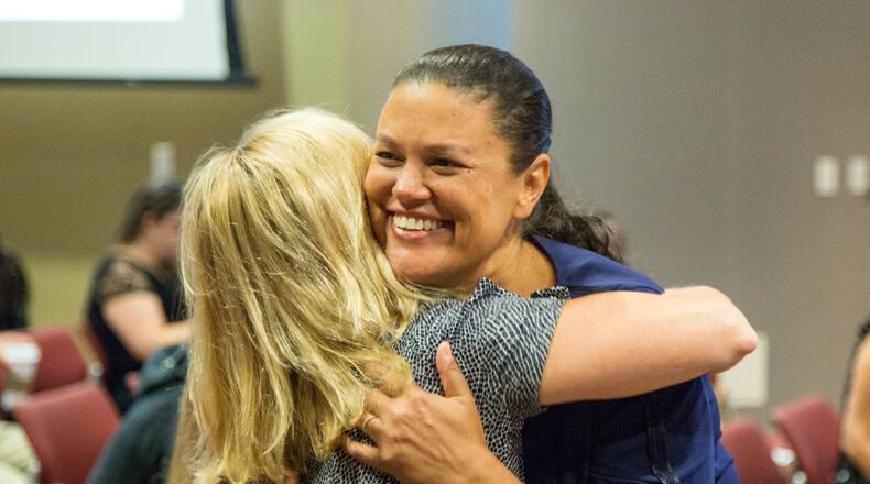 Superintendent Meria Carstarphen hugs a supporter before the Atlanta school board’s special meeting Monday to discuss her contract. PHIL SKINNER