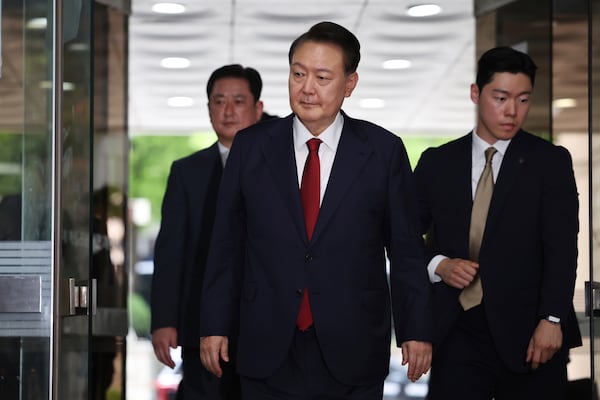 Former South Korean President Yoon Suk Yeol, centerm arrives at a court to attend a hearing to review his arrest warrant requested by special prosecutors in Seoul, South Korea Wednesday, July 9, 2025. (Kim Hong-Ji/Pool Photo via AP)