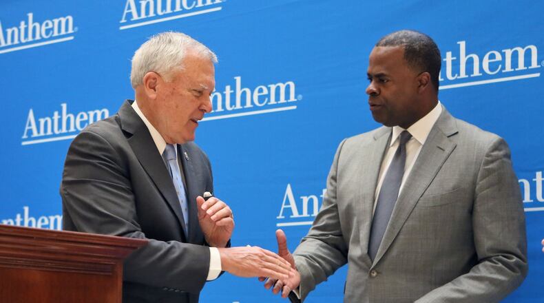 In this 2016 photo, Gov. Nathan Deal and former Atlanta Mayor Kasim Reed stand in front of a wall printed with the name of Anthem, the parent company of Blue Cross Blue Shield of Georgia. This week, Deal has announced that for the first 30 days the state will pay the extra out-of-network costs for state employees who have a state Blue Cross insurance plan and see Piedmont healthcare providers. The move could cost the state about $42 million. The state university system has done the same. PHOTO by BOB ANDRES /BANDRES@AJC.COM